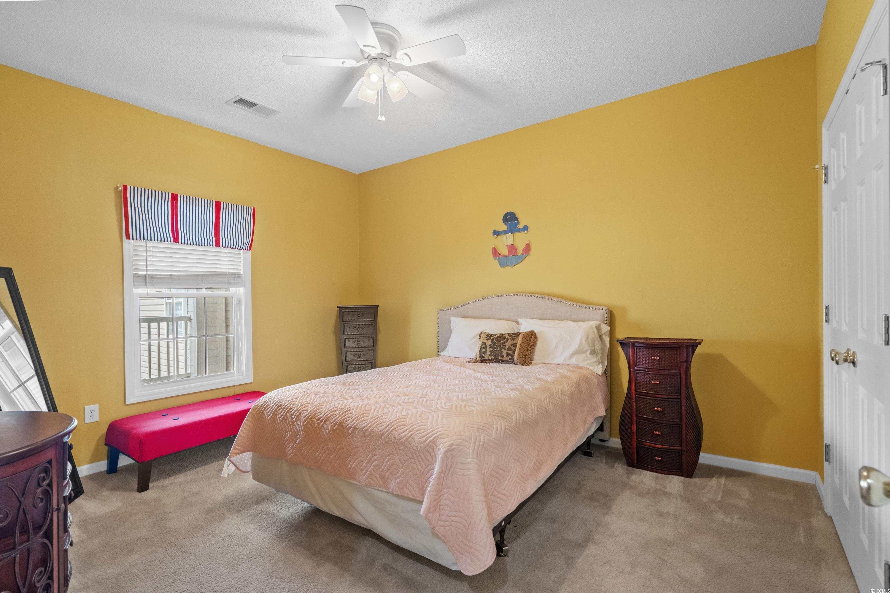 2050 Cross Gate Boulevard, Unit 303 Myrtle Beach, SC 29575 - Photo 27 of 35 Bedroom with a closet, light colored carpet, and ceiling fan