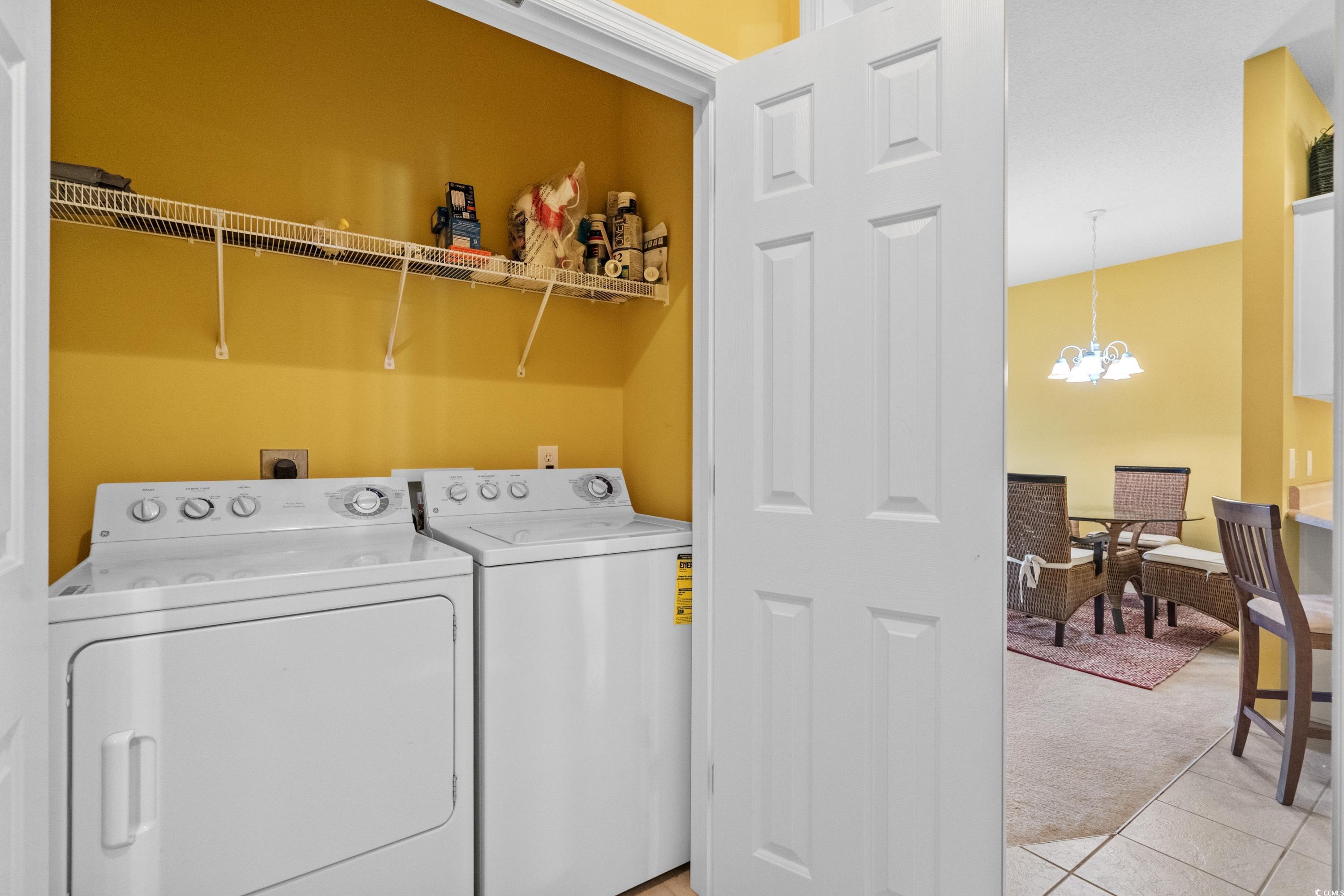 2050 Cross Gate Boulevard, Unit 303 Myrtle Beach, SC 29575 - Photo 30 of 35 Laundry room with a chandelier, independent washer and dryer, and light tile patterned floors