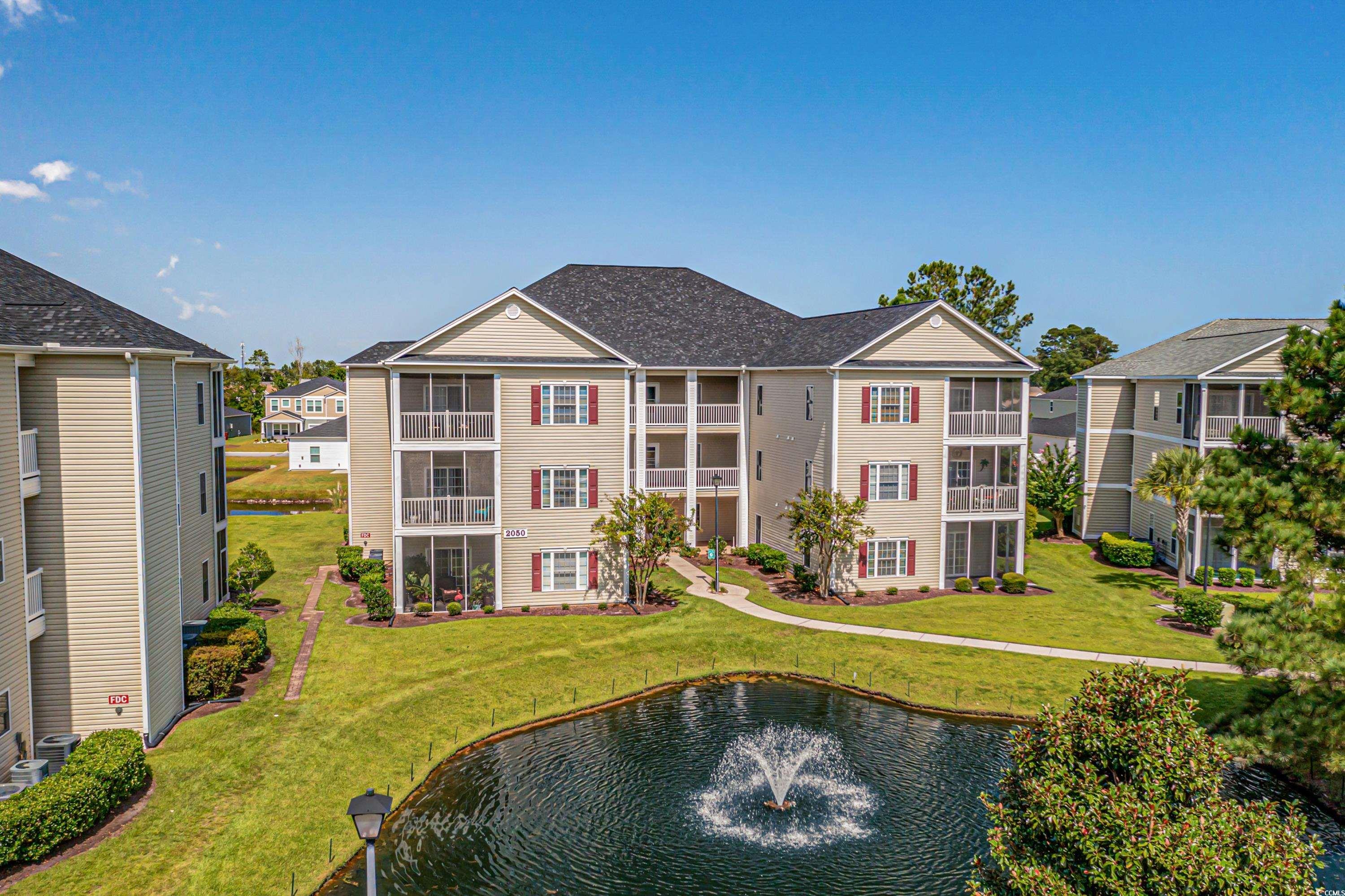 2050 Cross Gate Boulevard, Unit 303 Myrtle Beach, SC 29575 - Photo 31 of 35 Exterior space with a balcony and a lawn