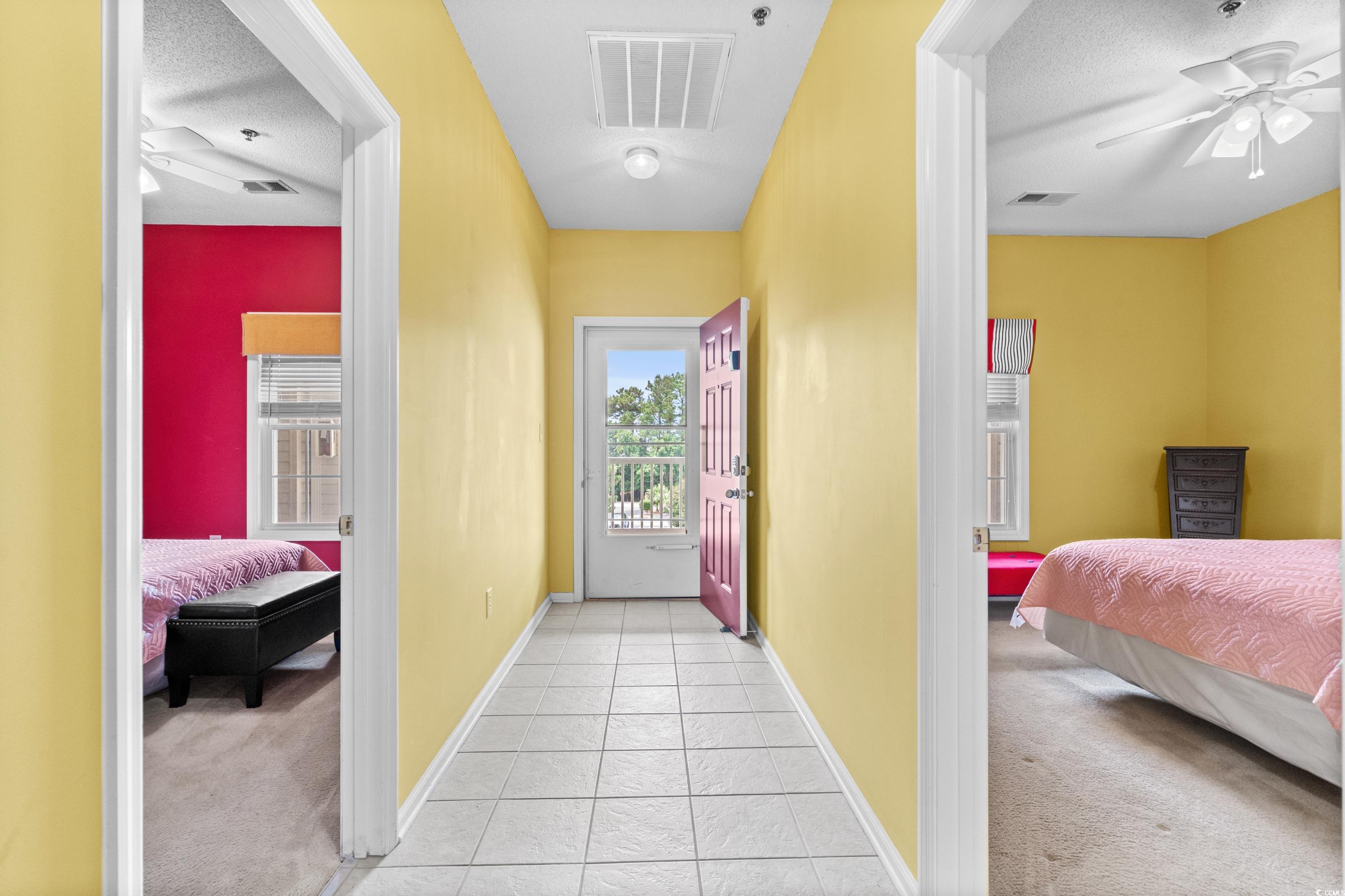 2050 Cross Gate Boulevard, Unit 303 Myrtle Beach, SC 29575 - Photo 34 of 35 Bedroom featuring ceiling fan, light carpet, and a textured ceiling