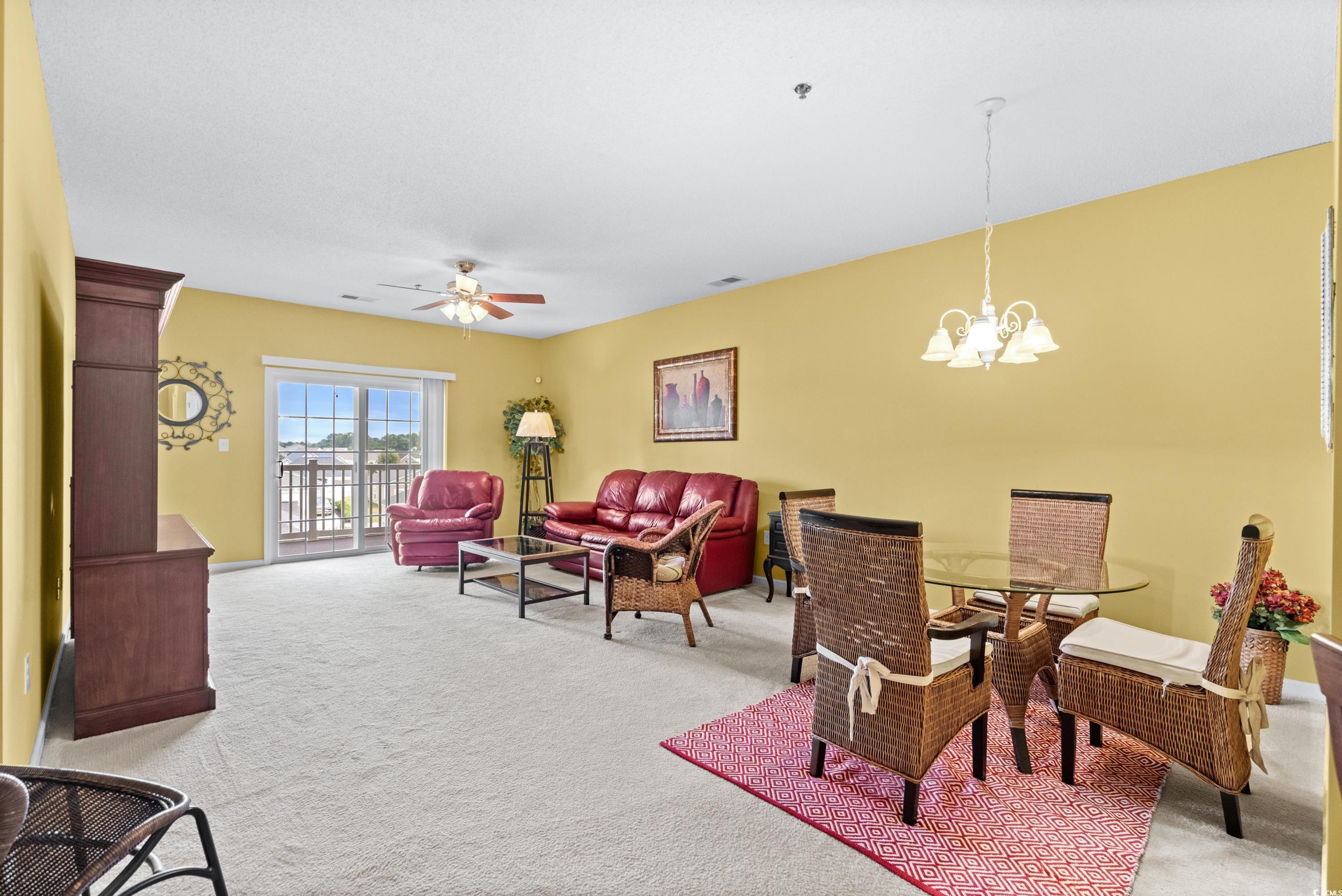 2050 Cross Gate Boulevard, Unit 303 Myrtle Beach, SC 29575 - Photo 5 of 35 Interior space featuring ceiling fan with notable chandelier and light carpet