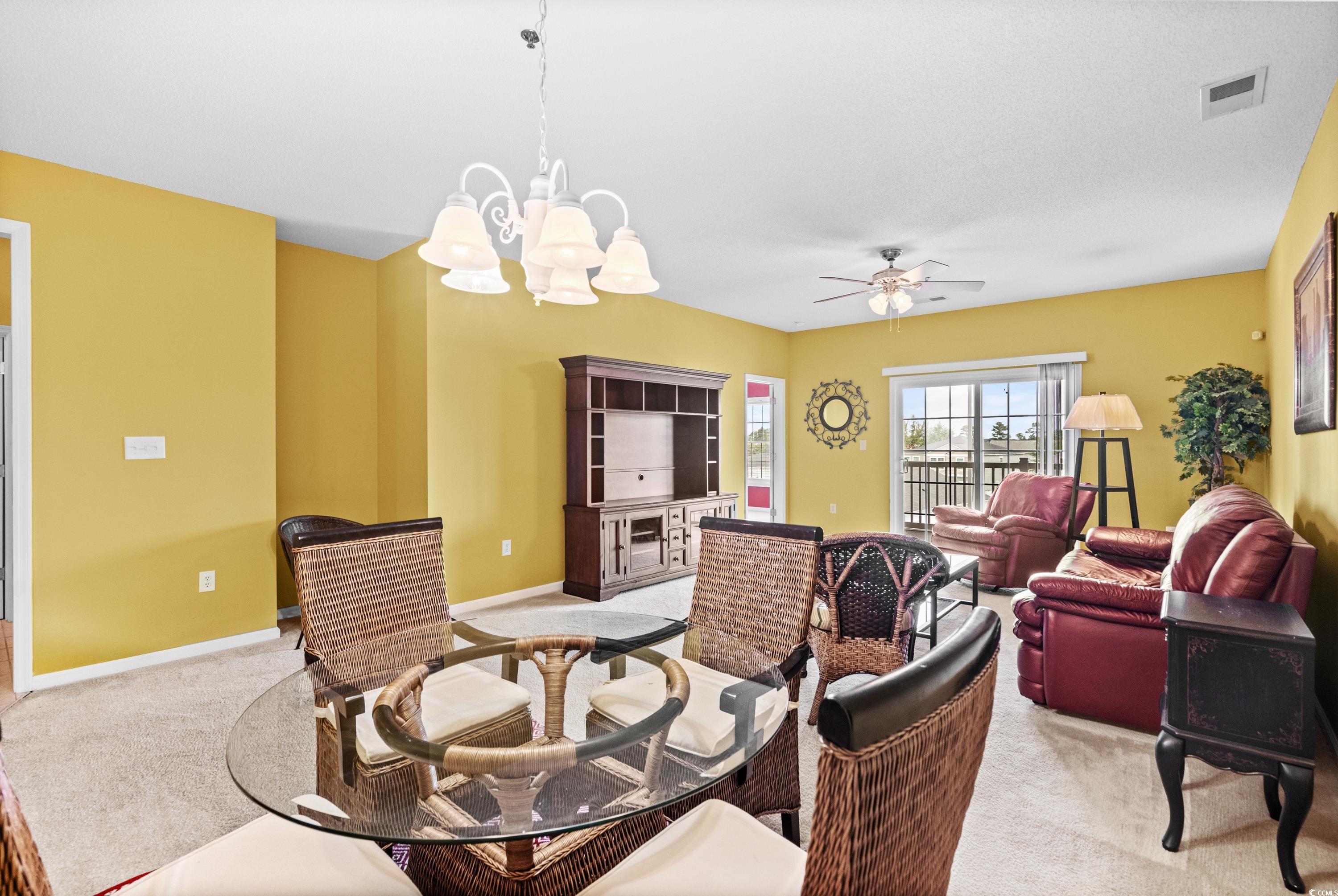 2050 Cross Gate Boulevard, Unit 303 Myrtle Beach, SC 29575 - Photo 10 of 35 Interior space with ceiling fan with notable chandelier and light carpet