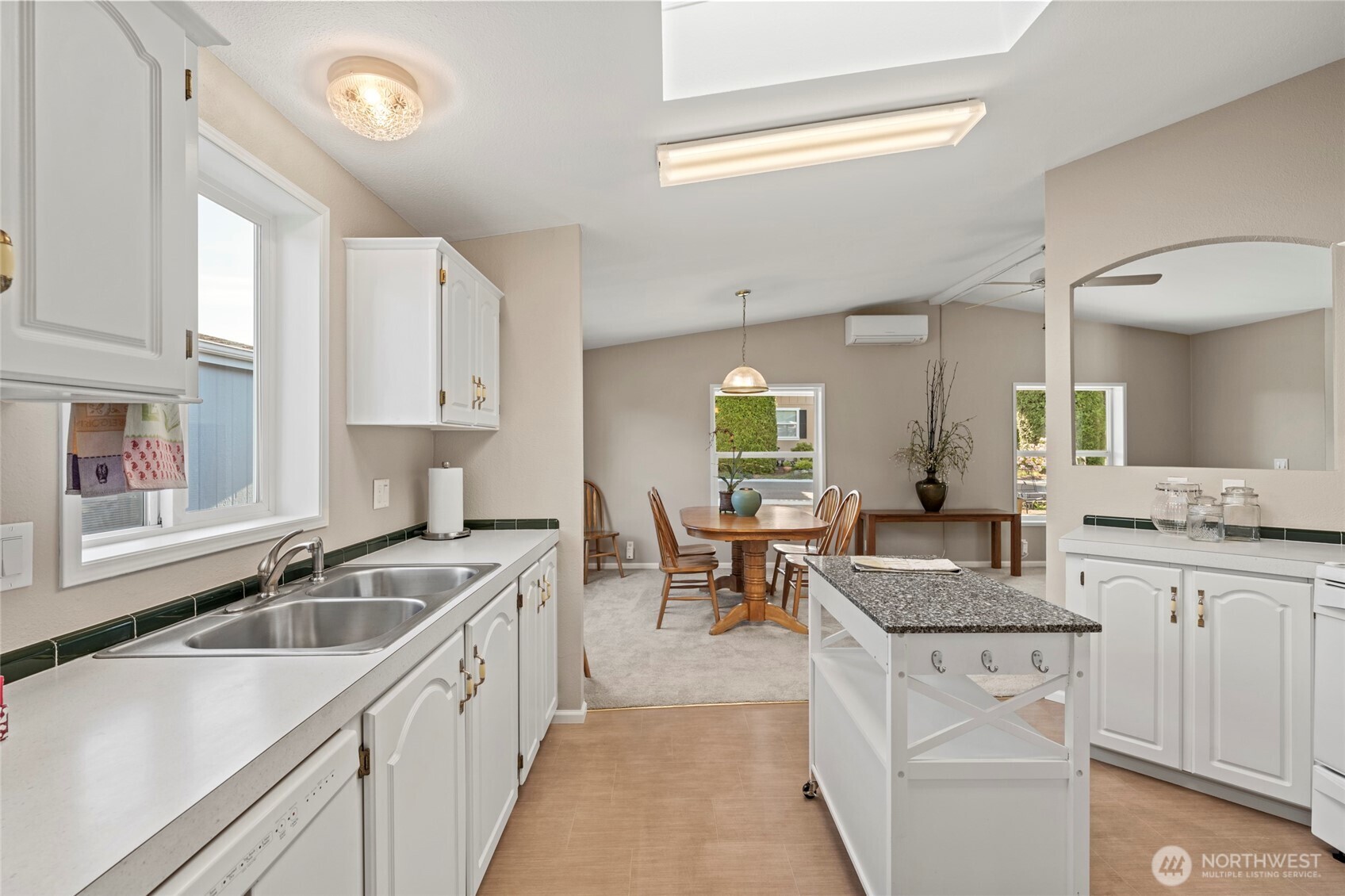 23825 15th Avenue Southeast, Unit 108 Bothell, WA 98021 - Photo 12 of 39 a kitchen with granite countertop a sink stove cabinets and living room