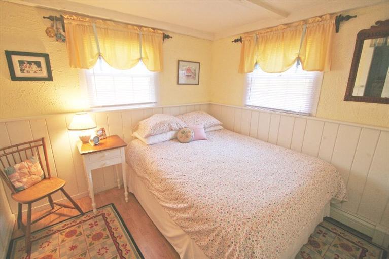 118 Richardson Road Centerville, MA 02632 - Photo 18 of 27 a bedroom with a bed and wooden floor
