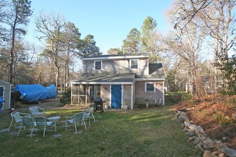 118 Richardson Road Centerville, MA 02632 - Photo 5 of 27 a view of a house with a yard chairs and a table