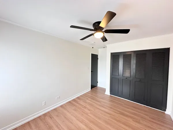 a view of empty room with wooden floor