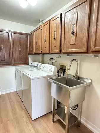 a utility room with a sink and a washer dryer