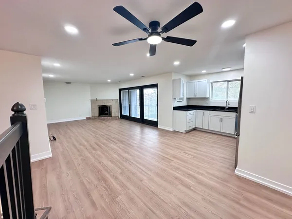 a view of a kitchen with a sink and wooden floor