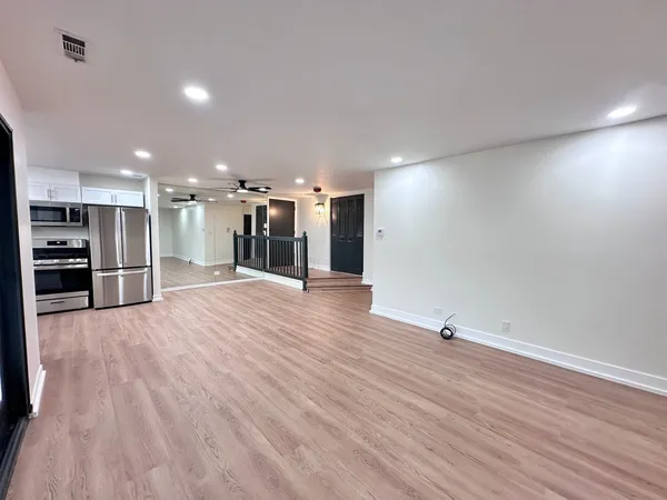 a view of a big room with wooden floors and chairs