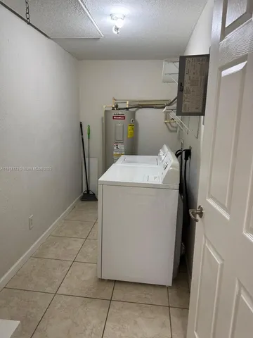 a view of a house with a tree in the background