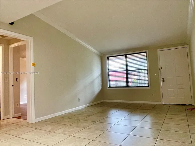 a kitchen with granite countertop a refrigerator and a stove top oven