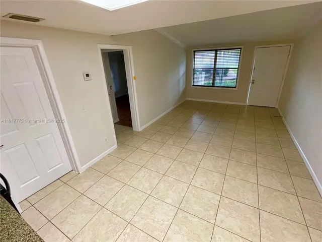 a kitchen with granite countertop a refrigerator and a stove top oven
