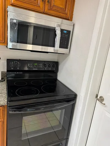 an empty room with wooden floor and entrance