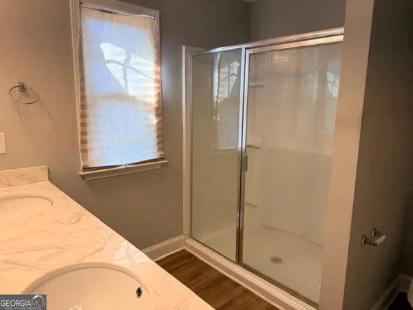 a bathroom with a shower and a sink