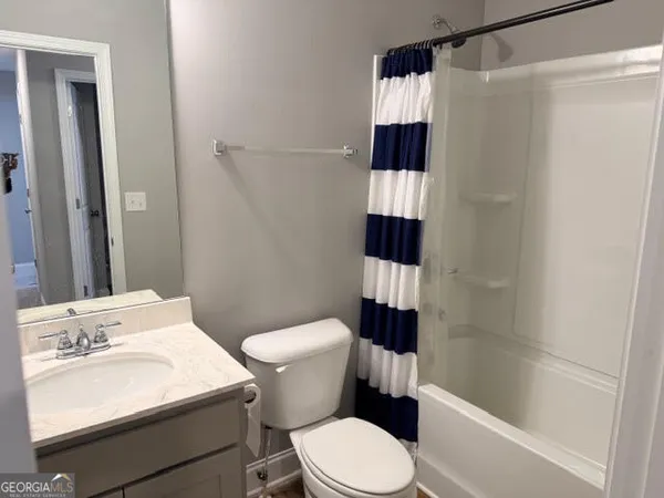 a white toilet sitting next to a bathroom sink