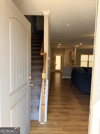 a view of a hallway with a couch and wooden floor