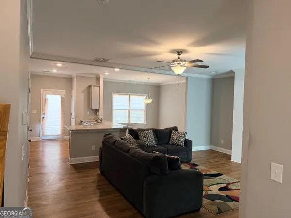a living room with furniture and a chandelier