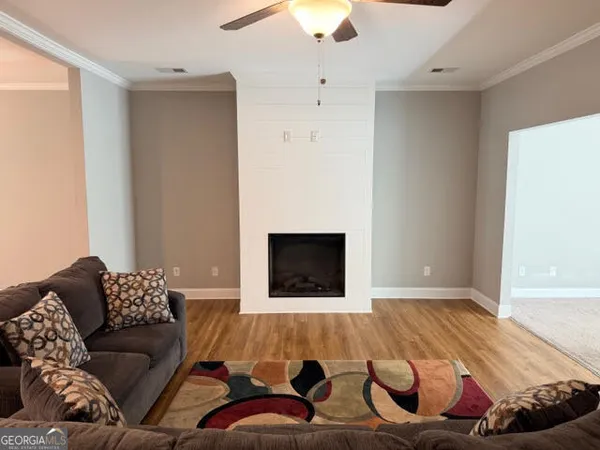 a living room with furniture and a fireplace