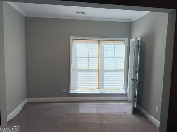 a bathroom with a bathtub and next to a window