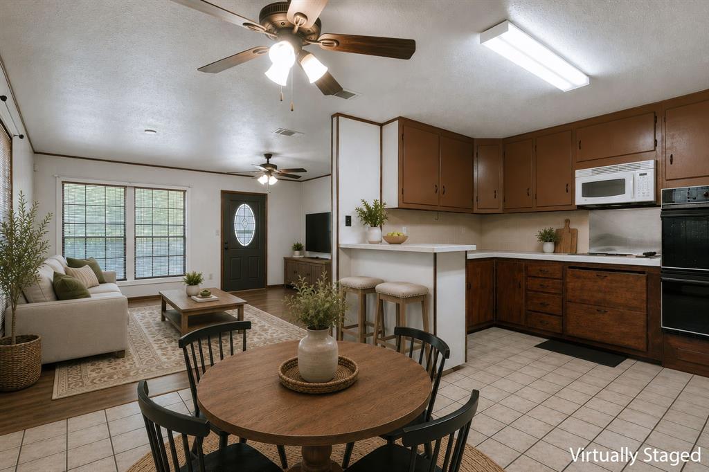 373 Ingred Street Waco, TX 76705 - Photo 7 of 39 a kitchen with a dining table and chairs