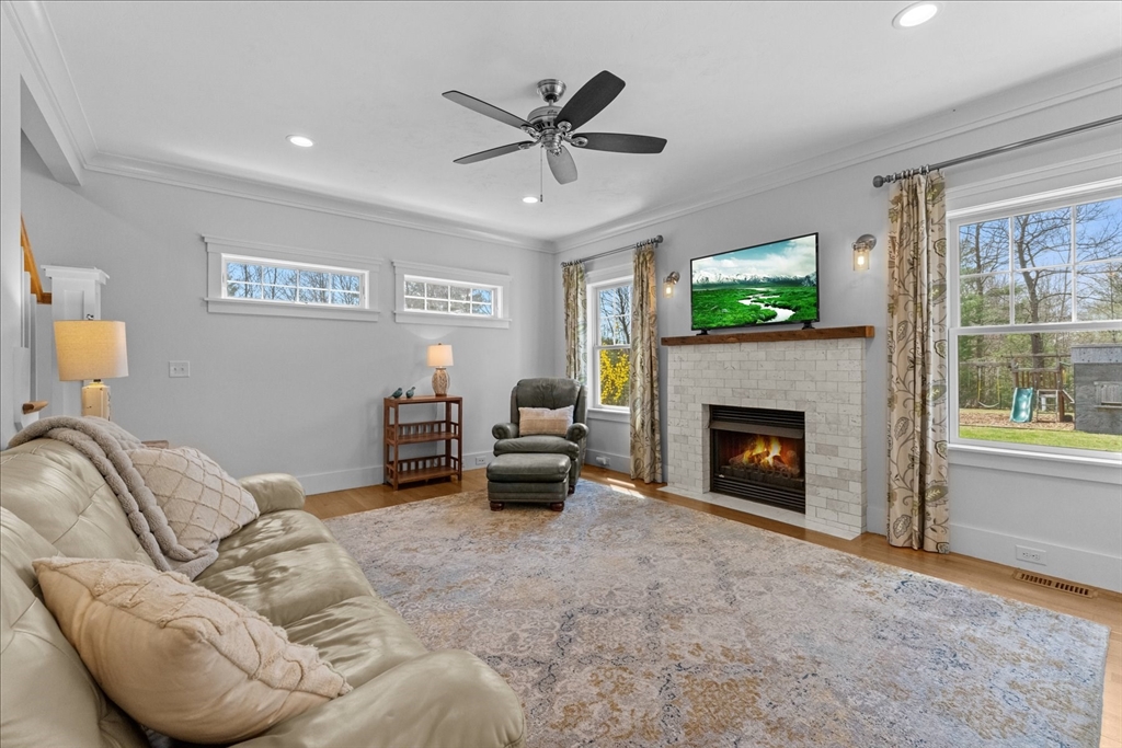 50 Quabbin Path Sutton, MA 01590 - Photo 20 of 42 a living room with furniture a fireplace and a flat screen tv
