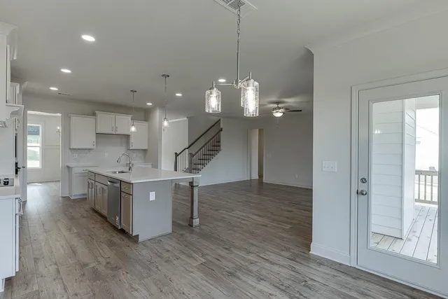 a kitchen with kitchen island stainless steel appliances a stove refrigerator sink and microwave