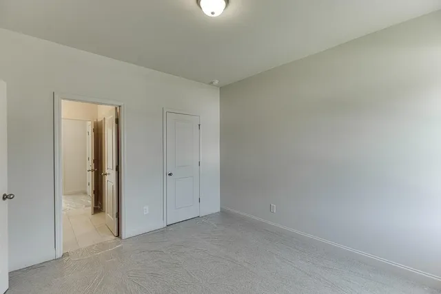 a view of an empty room and closet area