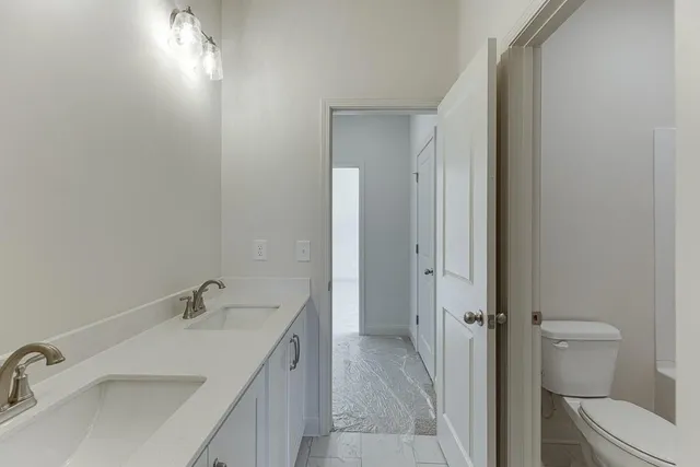 a bathroom with a sink toilet and shower