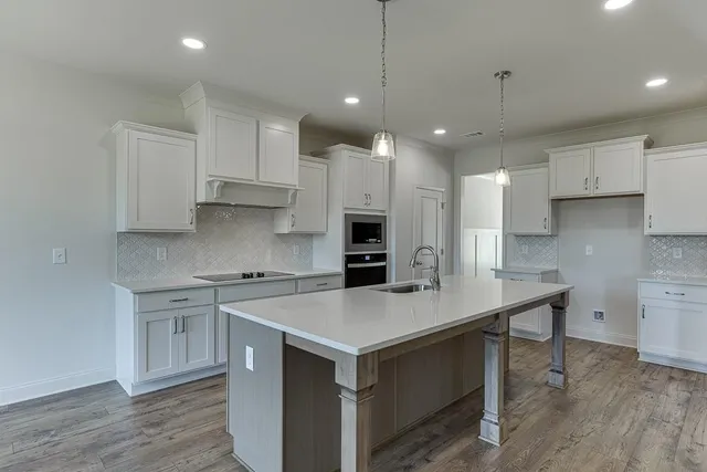 a kitchen with a stove a sink and a refrigerator