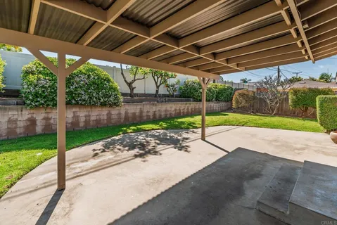 a view of a backyard with table and chairs