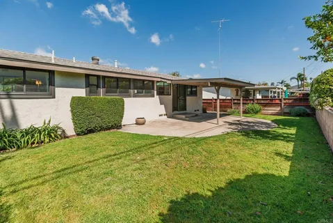 a front view of a house with a yard table and chairs
