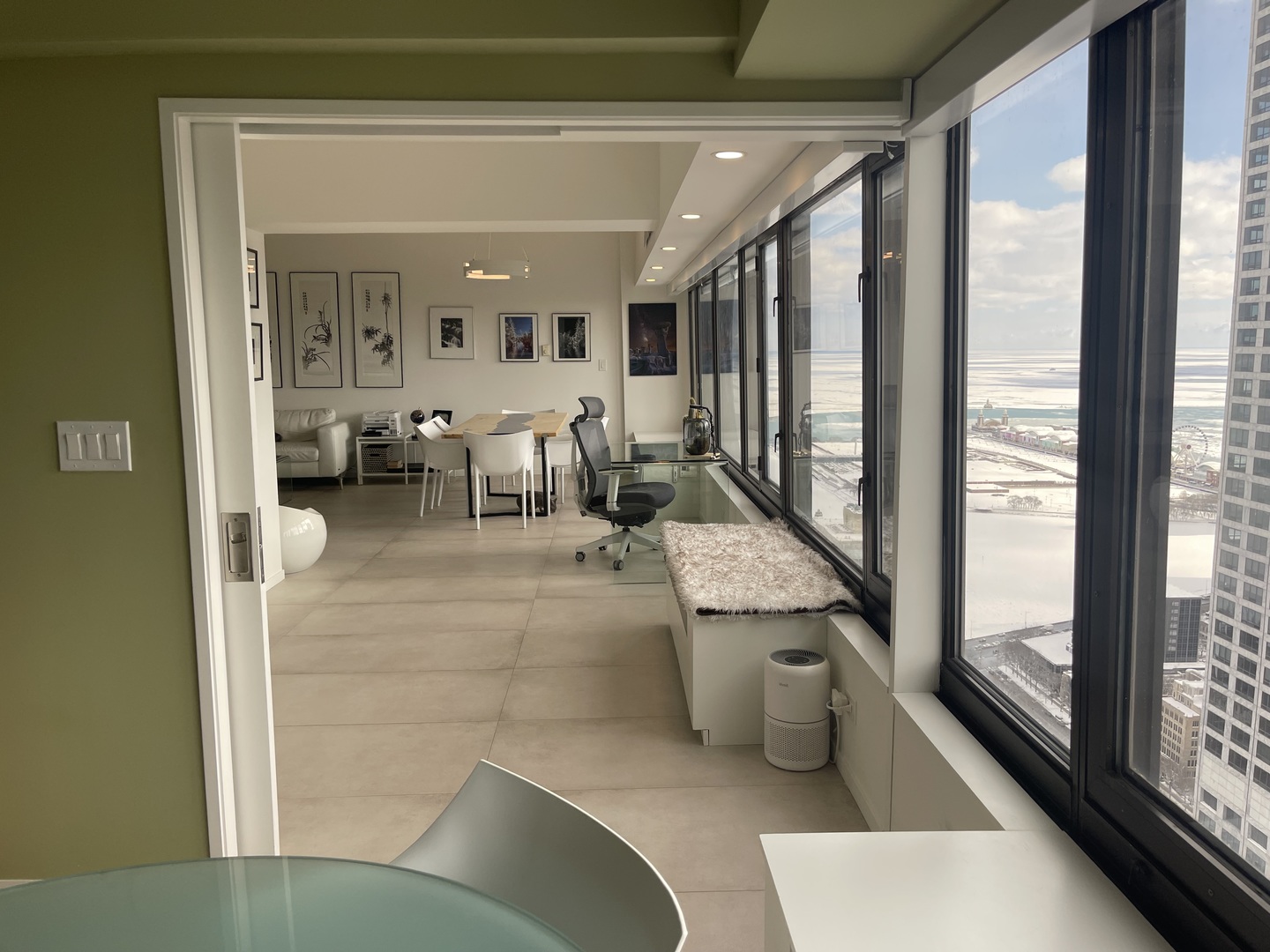 175 East Delaware Place, Unit 4723 Chicago, IL 60611 - Photo 15 of 26 a living room with couches and a large window with garden view