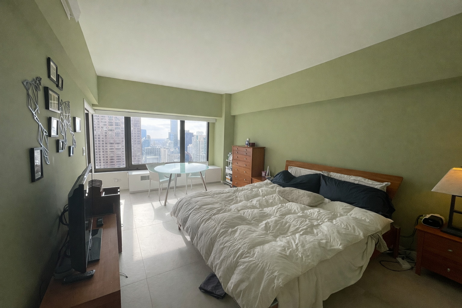 175 East Delaware Place, Unit 4723 Chicago, IL 60611 - Photo 20 of 26 a bed sitting in a bedroom next to a window