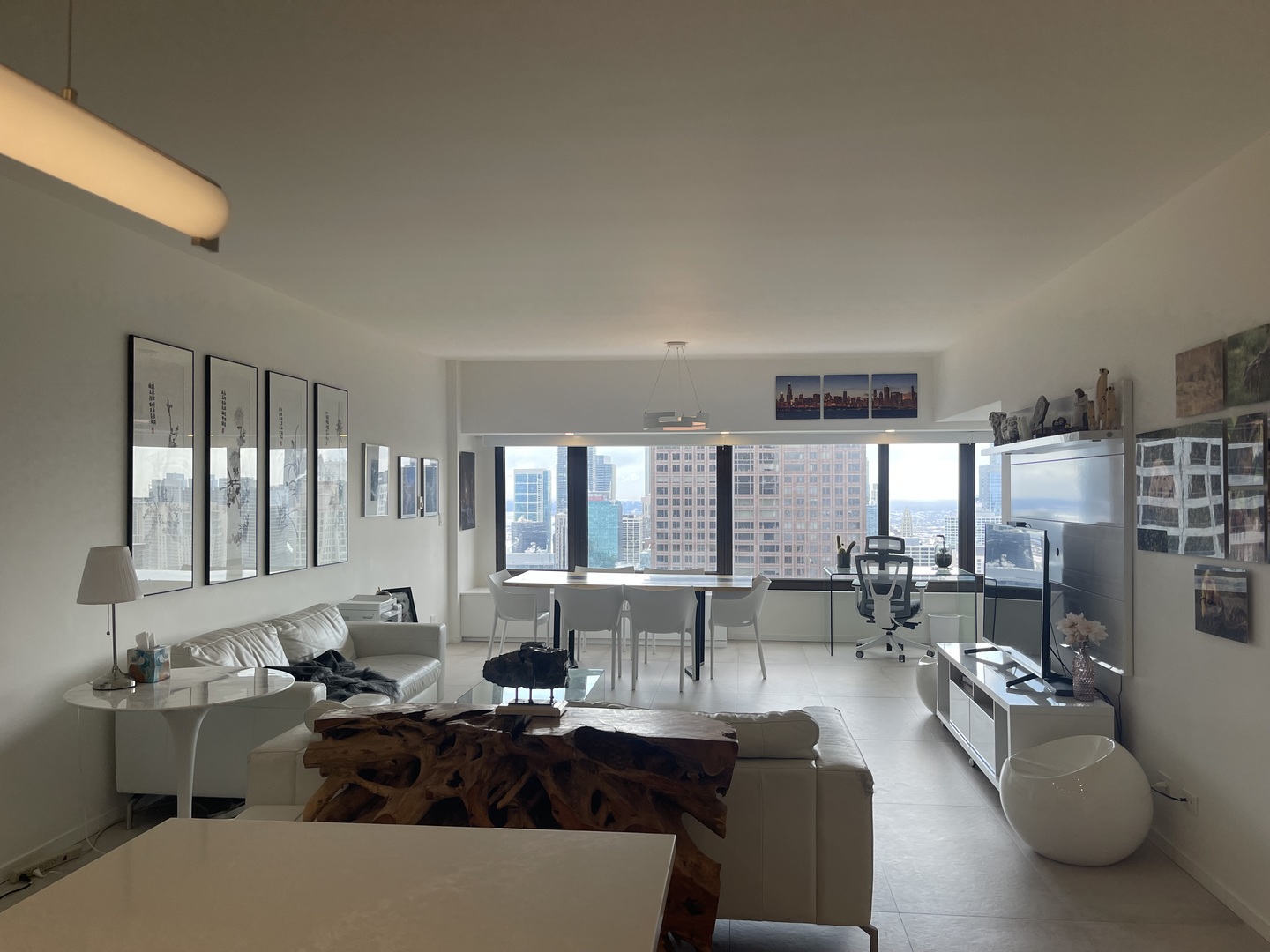 175 East Delaware Place, Unit 4723 Chicago, IL 60611 - Photo 7 of 26 a living room with furniture and large windows