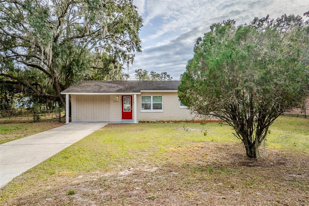 2311 Olivet Avenue Leesburg, FL 34748 - Photo 1 of 1 front view of a house with a yard and a large tree