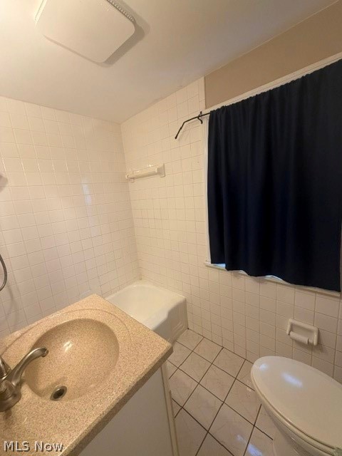 1388 Cranover Road Lyndhurst, OH 44124 - Photo 27 of 35 Bathroom featuring a vanity with integrated sink, a bathtub with a shower, and floor tiling