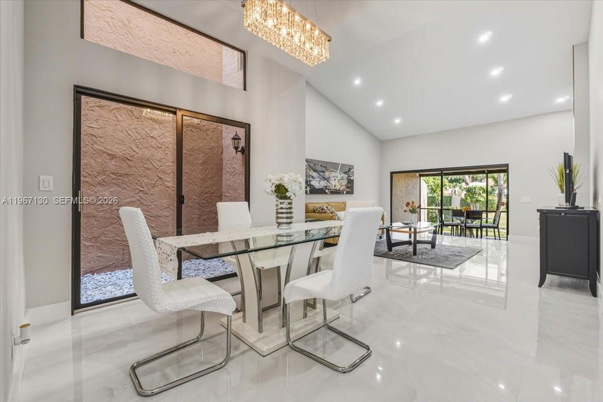 22708 Meridiana Drive Boca Raton, FL 33433 - Photo 1 of 49 a view of a dining room with furniture window and outside view