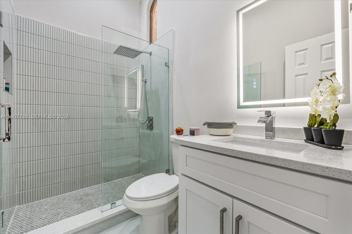 22708 Meridiana Drive Boca Raton, FL 33433 - Photo 16 of 49 a bathroom with a sink a toilet and shower