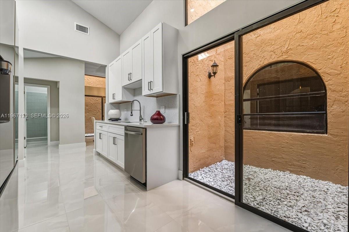 22708 Meridiana Drive Boca Raton, FL 33433 - Photo 17 of 49 a view of kitchen with washer and dryer