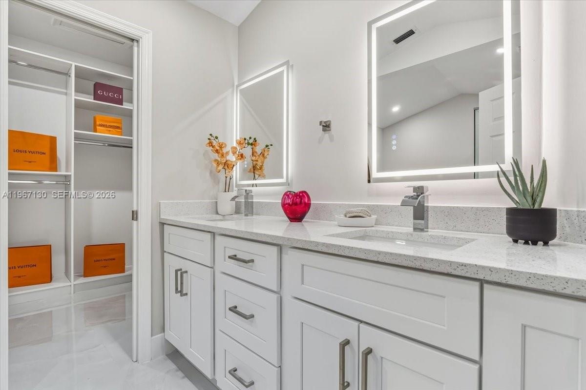 22708 Meridiana Drive Boca Raton, FL 33433 - Photo 22 of 49 a bathroom with a granite countertop sink a vanity and shower