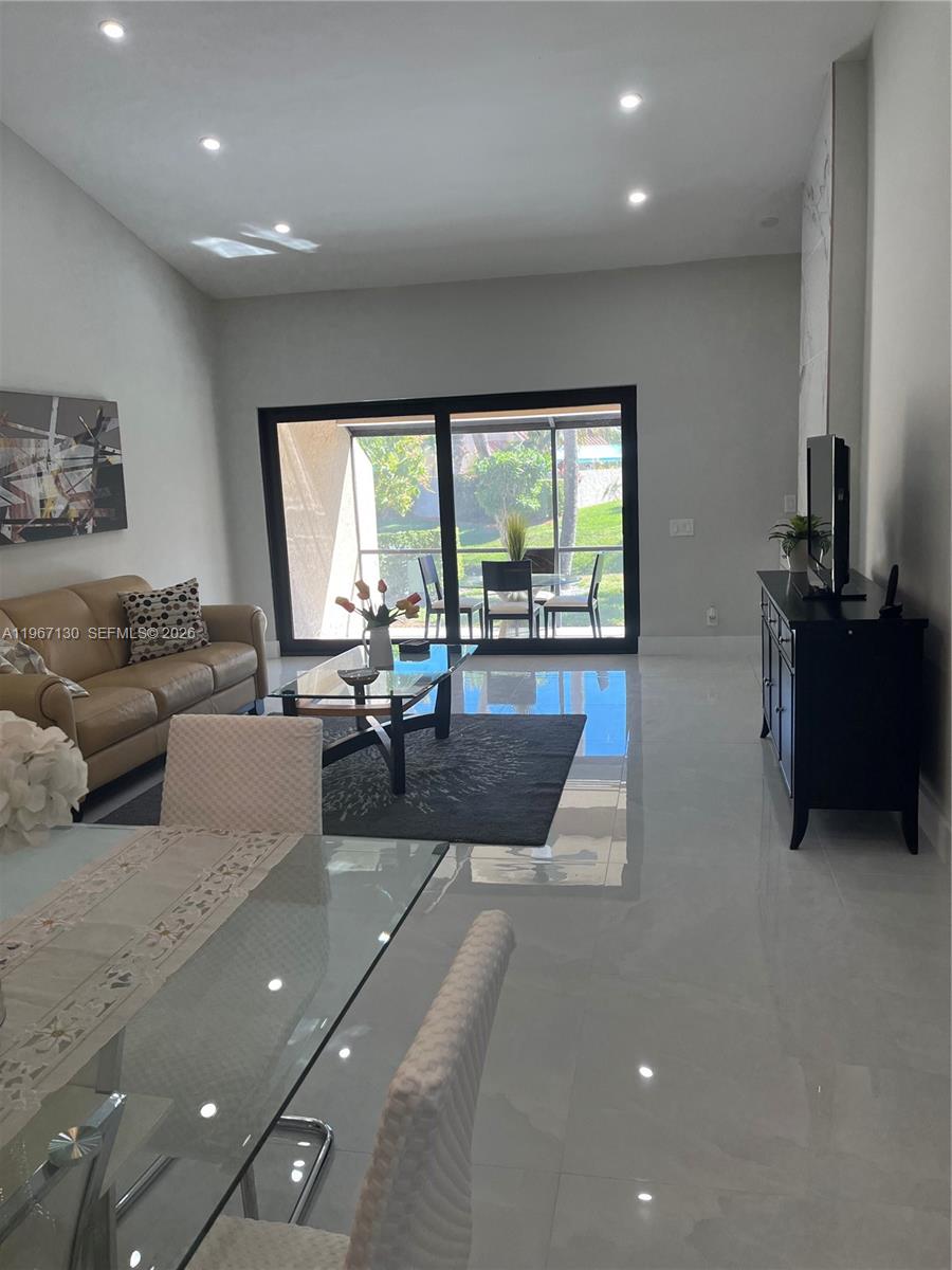 22708 Meridiana Drive Boca Raton, FL 33433 - Photo 32 of 49 a living room with furniture and a large window