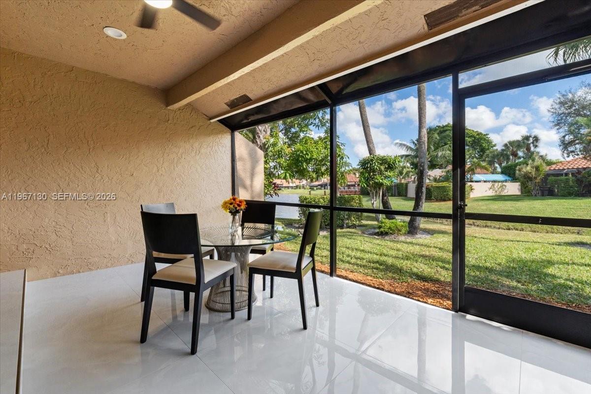 22708 Meridiana Drive Boca Raton, FL 33433 - Photo 36 of 49 a view of a porch with furniture and a yard