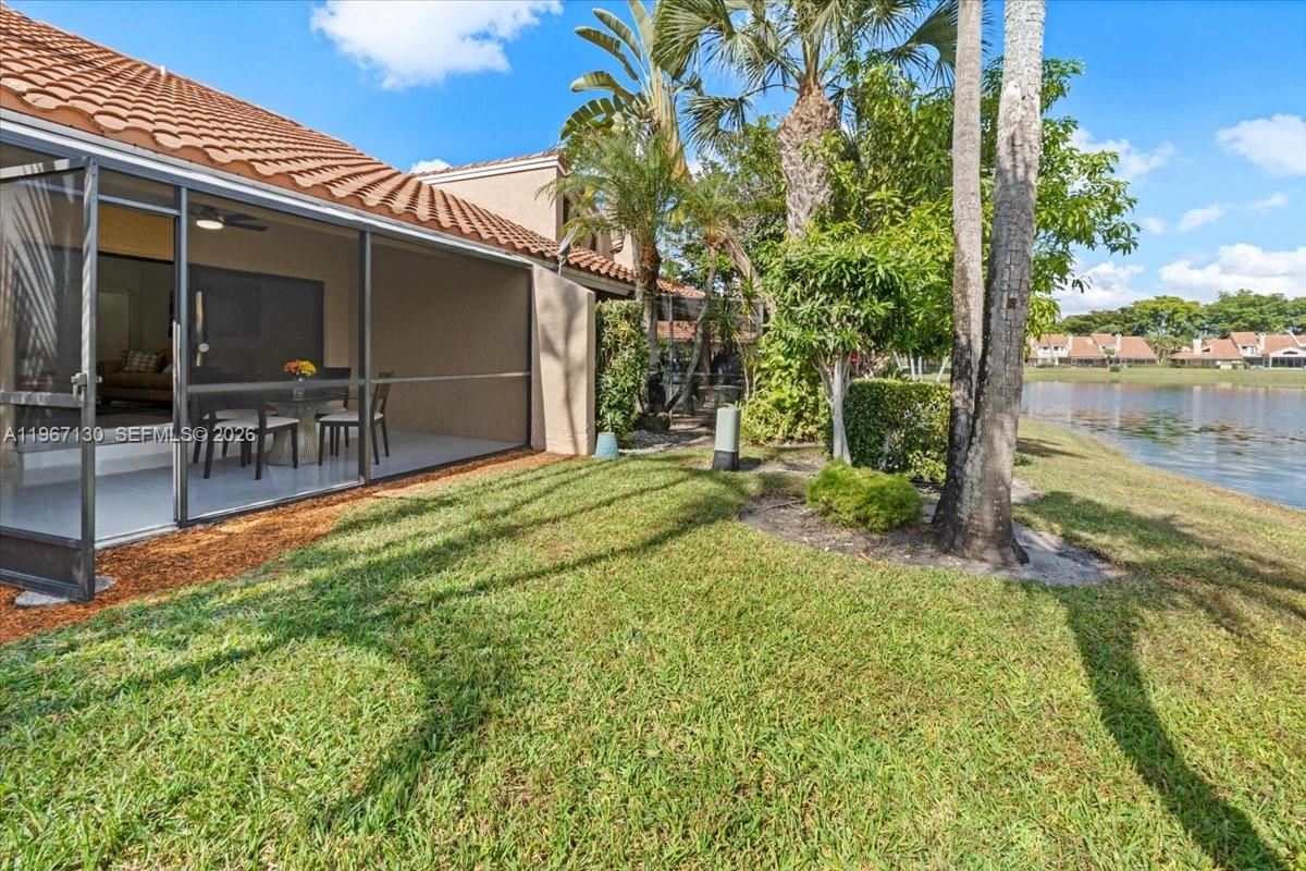 22708 Meridiana Drive Boca Raton, FL 33433 - Photo 46 of 49 a view of a backyard with table and chairs and potted plants
