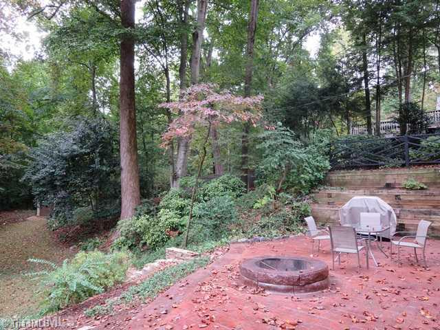 1760 Robinhood Road Winston-Salem, NC 27104 - Photo 15 of 16 Exterior Back. Stamped concrete patio with fire pit. Overlooks backyard.