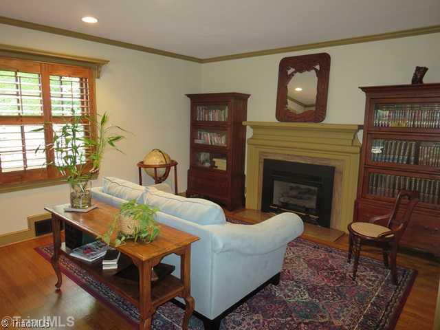 1760 Robinhood Road Winston-Salem, NC 27104 - Photo 3 of 16 Living Room. Wood Floors, Plantation Shutters, and Gas Fireplace