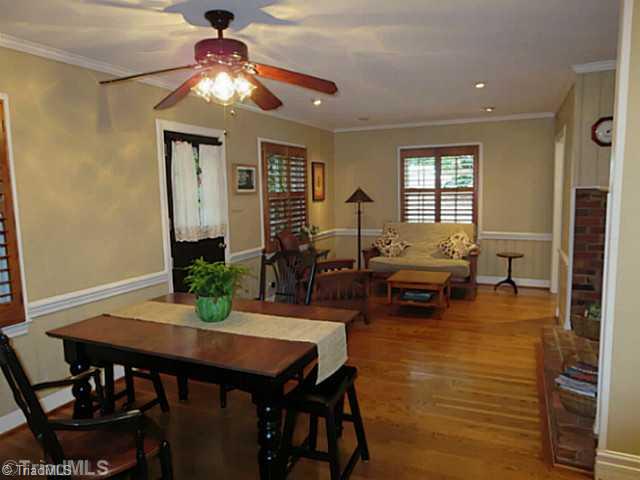 1760 Robinhood Road Winston-Salem, NC 27104 - Photo 4 of 16 Dining Room. Wood Floors, Plantation Shutters, Fireplace, Dutch Door that leads to brick patio.