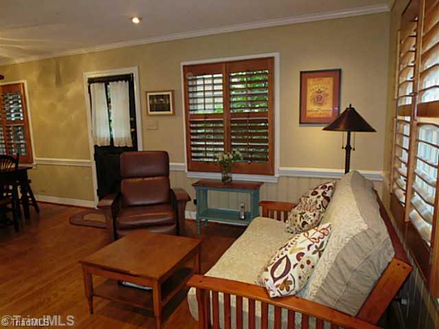 1760 Robinhood Road Winston-Salem, NC 27104 - Photo 5 of 16 Den/Family/Great Room. Den with Wood Floors, Plantation Shutters, Fireplace, and Wainscoating
