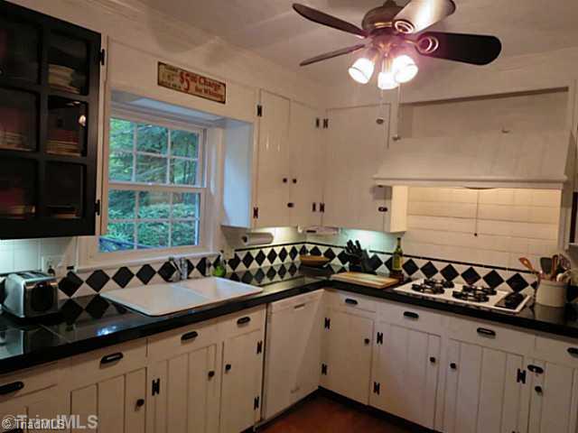 1760 Robinhood Road Winston-Salem, NC 27104 - Photo 7 of 16 Kitchen. Lots of Character and Charm for a kitchen! Glass front cabinets, granite counters, wood floors, and ceiling fan.