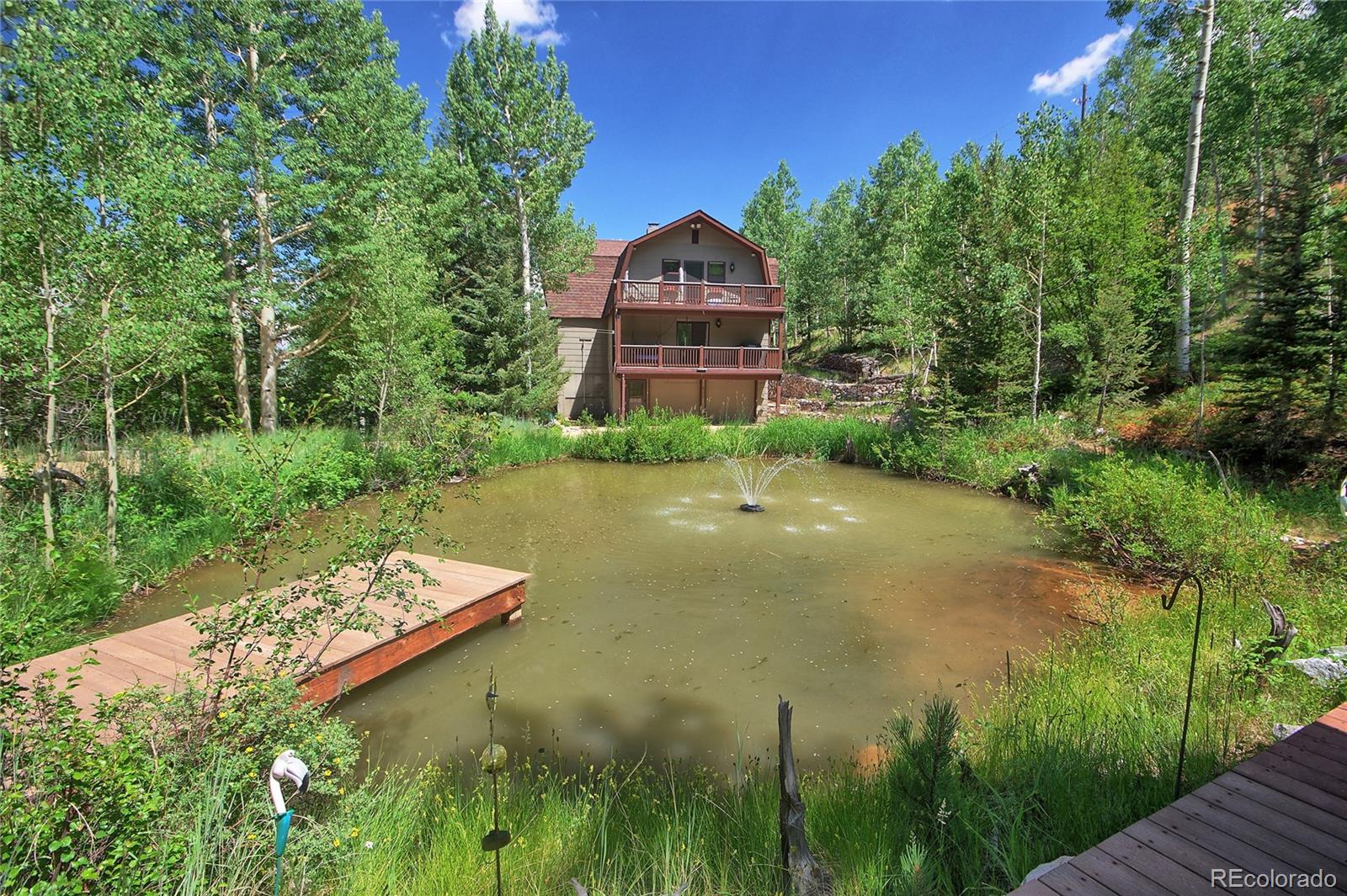 6250 Waterfall Loop Manitou Springs, CO 80829 - Photo 1 of 36 a view of a lake with a building in the background