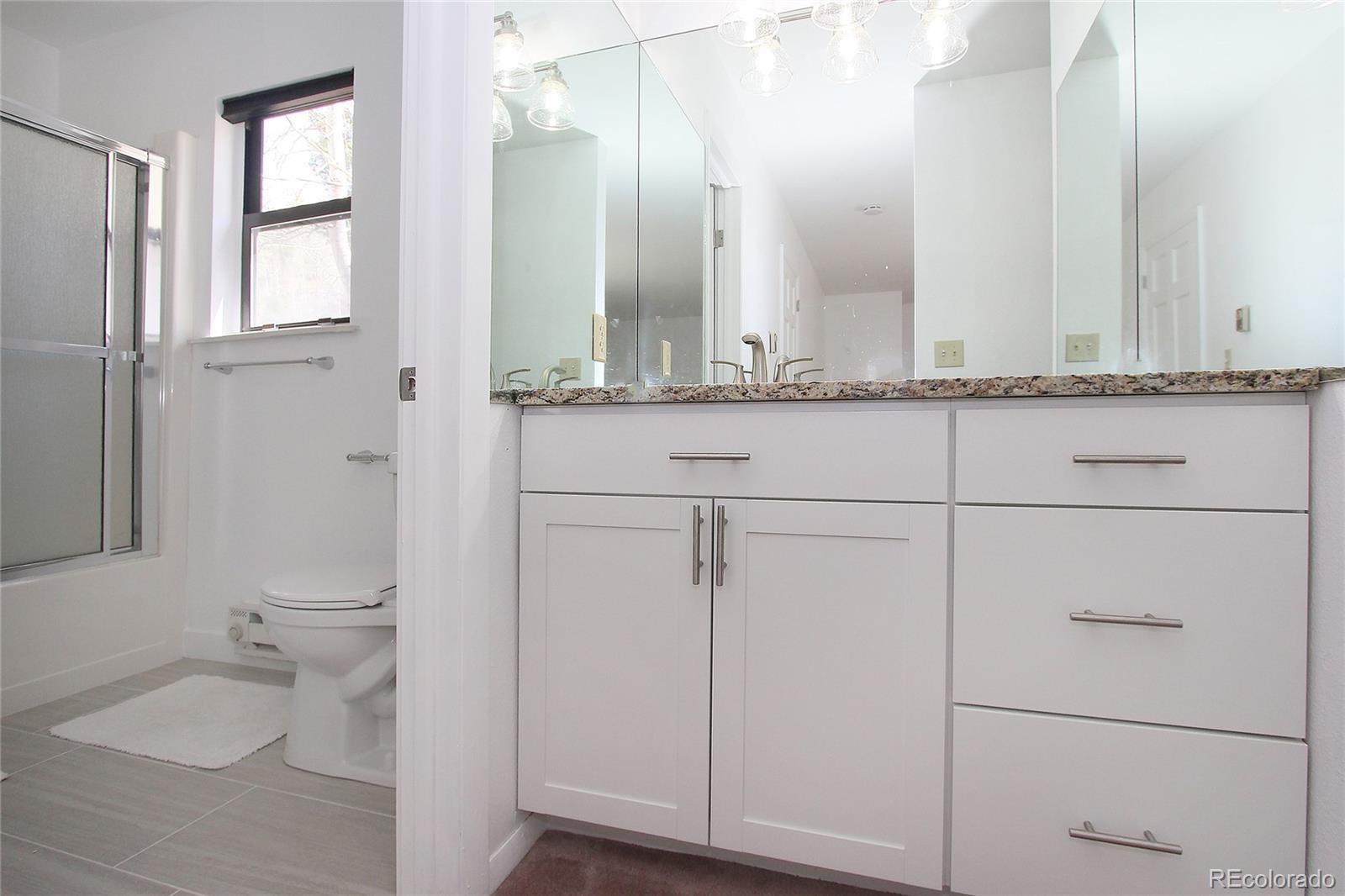 6250 Waterfall Loop Manitou Springs, CO 80829 - Photo 15 of 36 a bathroom with a granite countertop sink and a toilet